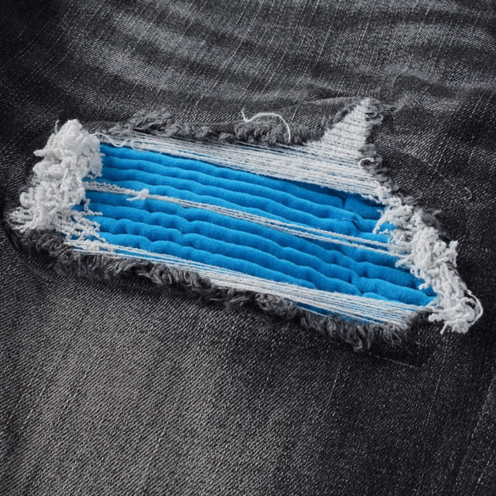 Amiri Luxus Herren Slim Fit Jeans mit auffälligen blauen Patches