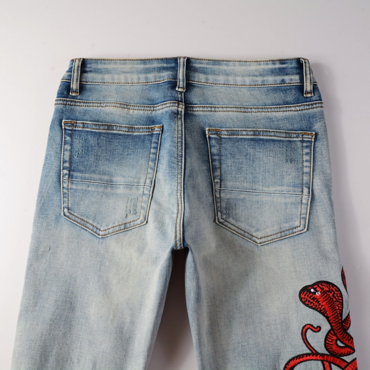 Amiri Fire Snake Jeans: Luxuriöse Designer-Denim mit feuriger Schlangenstickerei